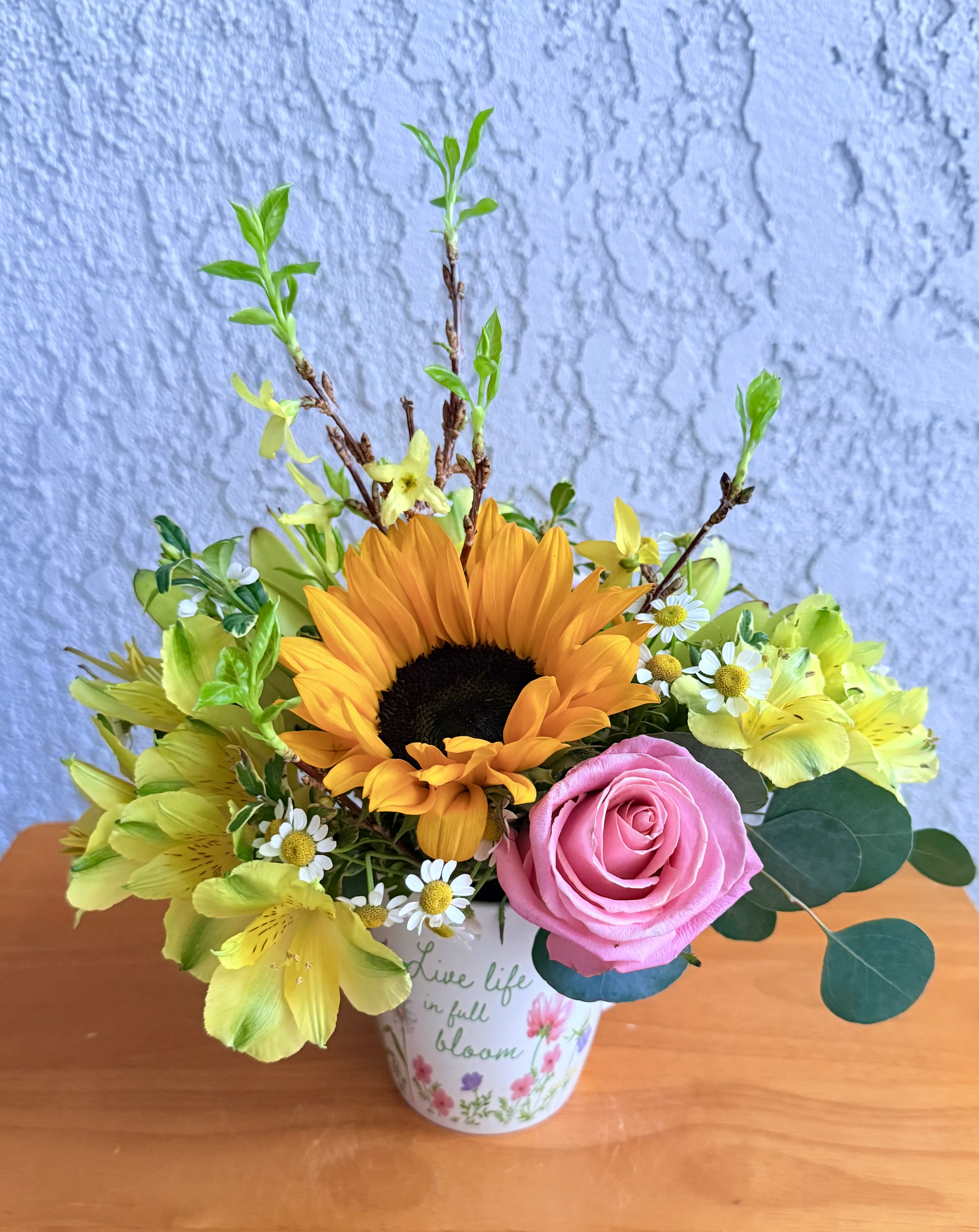 A Cup  of Floral Joy  - Spring is here, enjoy the beautiful weather and the beautiful flowers of the Spring season.This floral cup is crafted with premium flowers: delicate alstroemerias, sunny sunflowers, bright yellow floral branches, seasonal foliage, Ecuadorian roses and decorative chamomile. Small size Garden style 