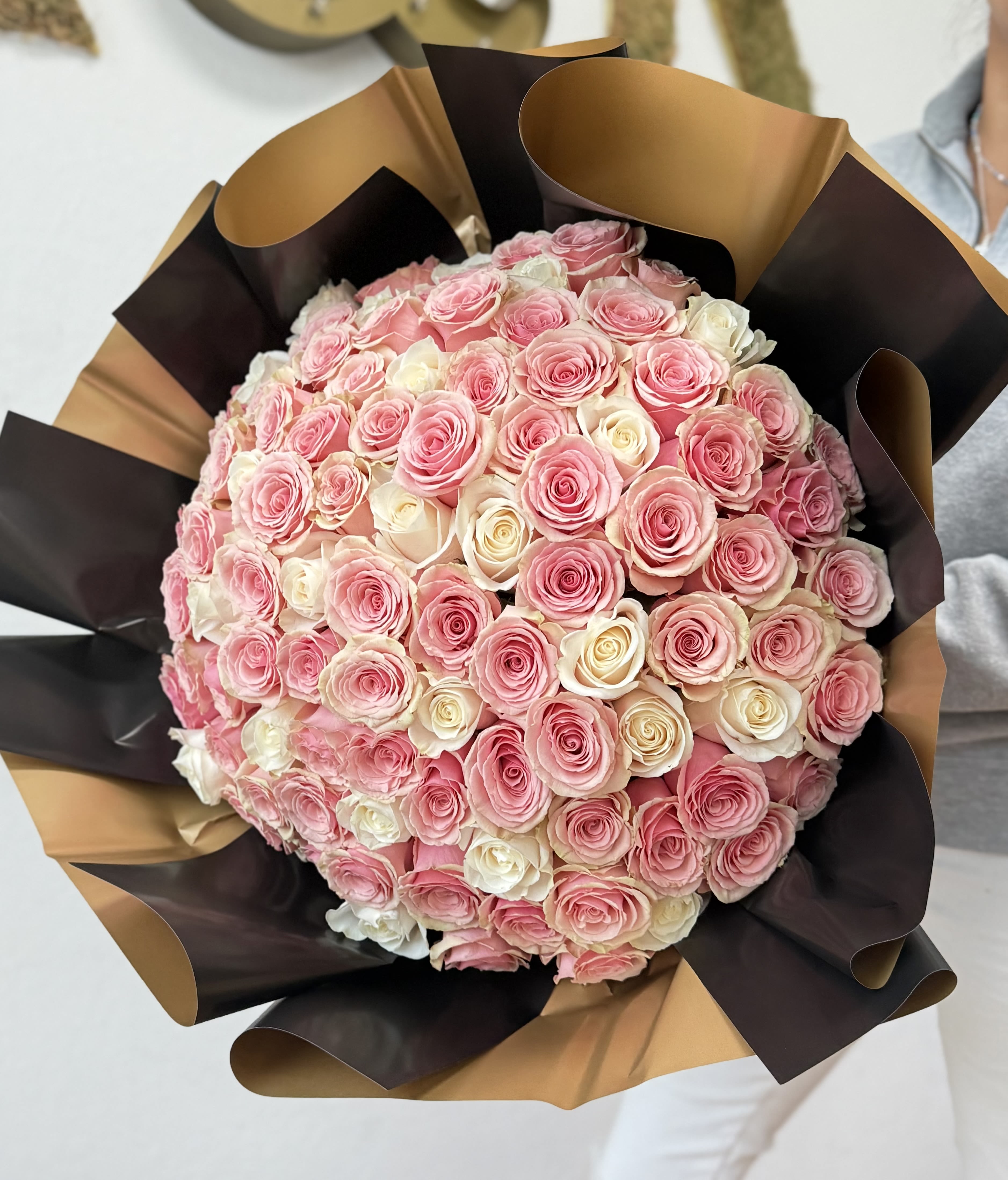 100 Roses Bouquet Pink and White - 100 long-stem pink and white roses with decorative wrapping paper. One hundred roses bouquets come WITH a clear vase.