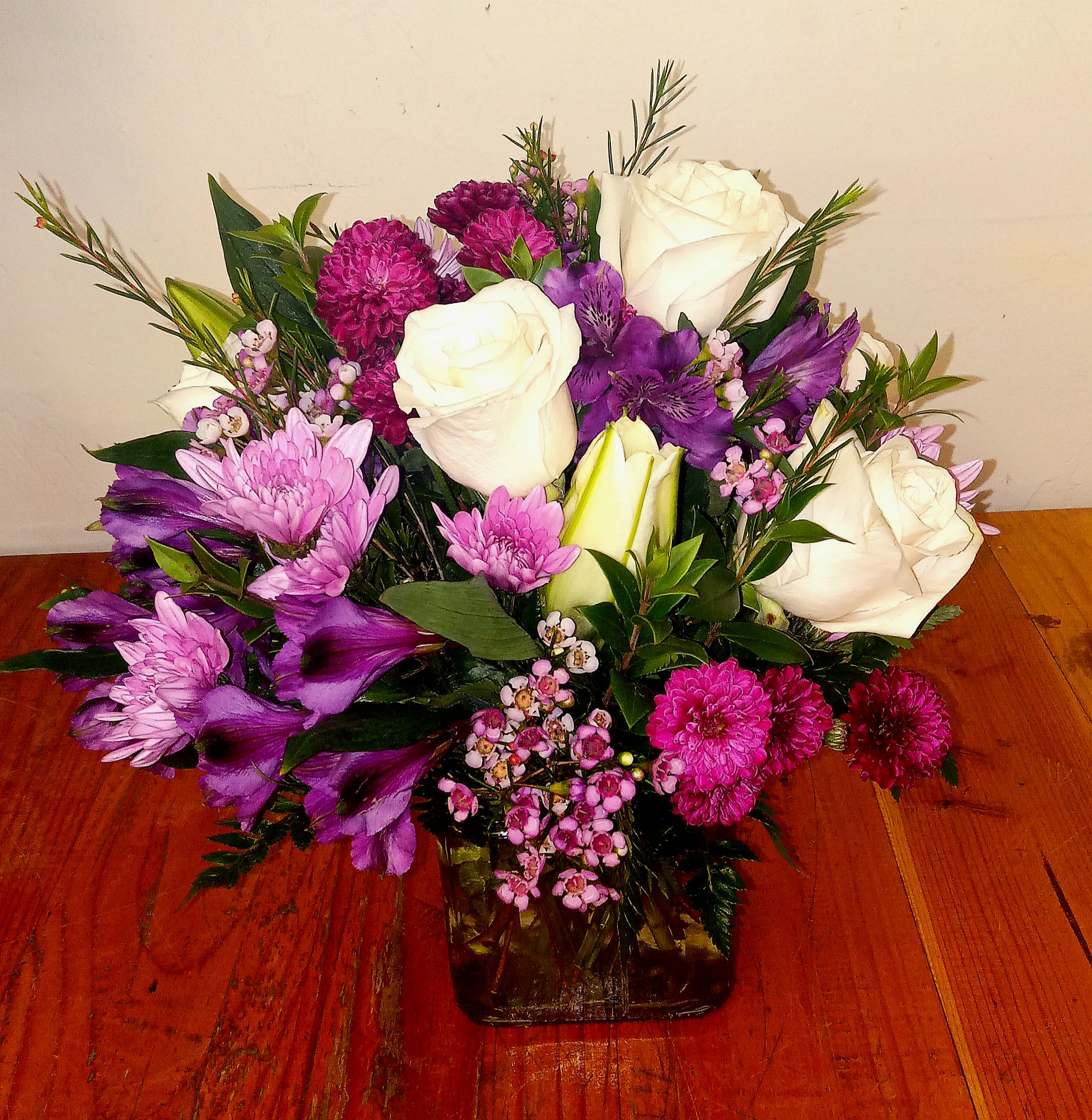 Everlasting Lavender Bouquet - The Everlasting Lavender Bouquet features a serene blend of lavender and white flowers, beautifully arranged to evoke a natural and calming ambiance. Presented in a sleek glass cube vase, it offers and timeless and elegant display for any setting.