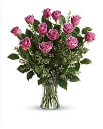 Dozen Lavender Roses In Vase - This arrangement is the perfect "pick me up" to brighten someone's day. Dozen Long Stemmed Lavender Roses by BloomNation™ is the perfect gift for a birthday, get well, just because, and thank you.    Arrangement Details: 12 Long Stemmed Lavender Roses and Assorted Greenery APPROXIMATE DIMENSIONS: 25" H X 18" W