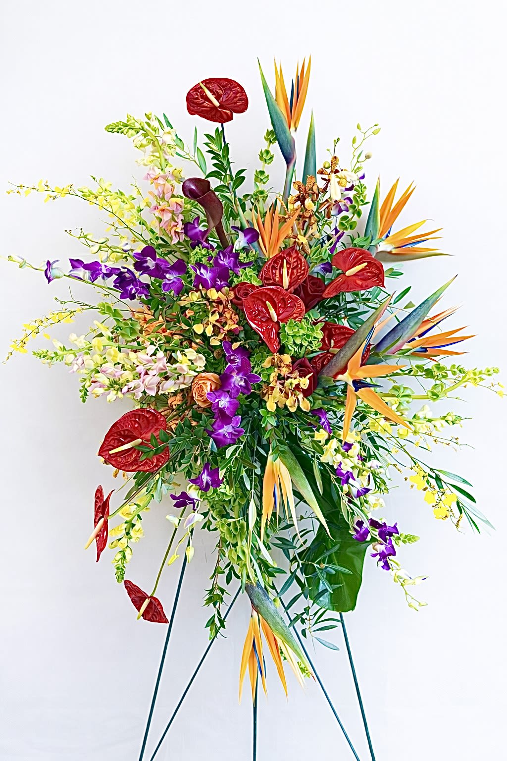 Tropical Celebration Spray - A vibrant tropical standing spray with exotic blooms and lush greenery, perfect for funeral services, memorials, or celebrations of life.