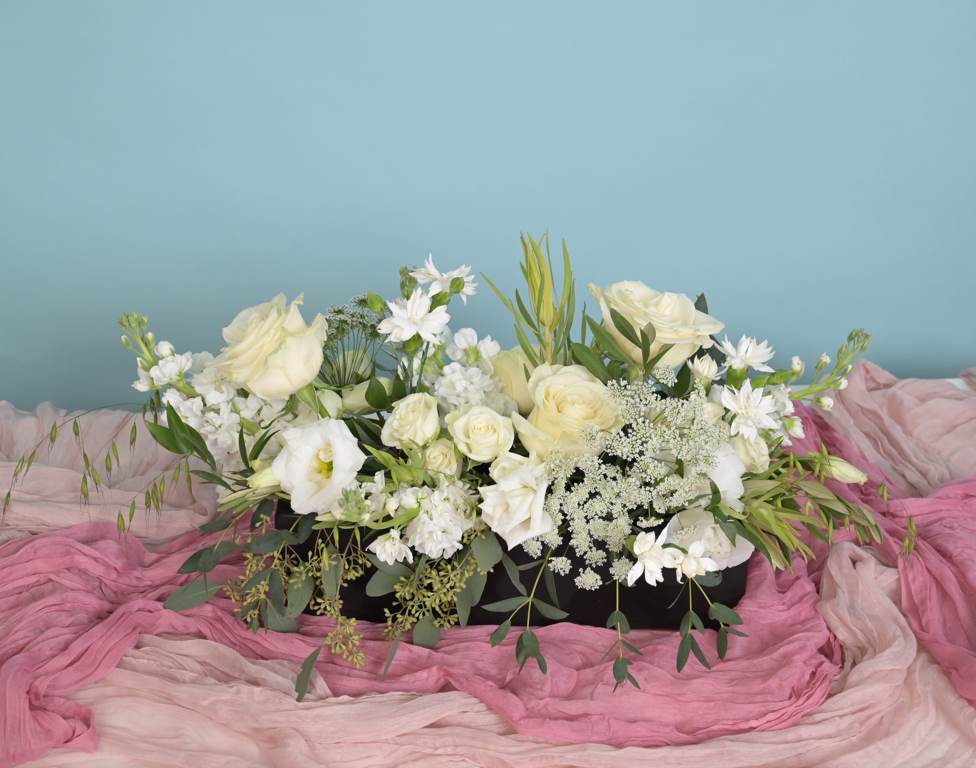 Serene Blooms - White has never been a simple color. In the right hands it becomes every shade of light — warm, cool, golden, luminous — all depending on the bloom and the moment. Serene Blooms is a soft, airy composition of white and cream flowers with gentle texture and quiet movement. No drama, no fuss. Just the kind of arrangement that makes a room feel peaceful the second it walks in. Beautiful for sympathy, for new beginnings, for anyone who finds clarity in simplicity. Each arrangement is handcrafted and one of a kind. Flower types and stem placement vary with every piece based on what's most beautiful and fresh that day. The vessel shown may be substituted with one of equal character and quality. Same-day delivery available to Raleigh, Cary, Durham, Chapel Hill, Morrisville, Apex, and Wake Forest — order before 2 PM. 