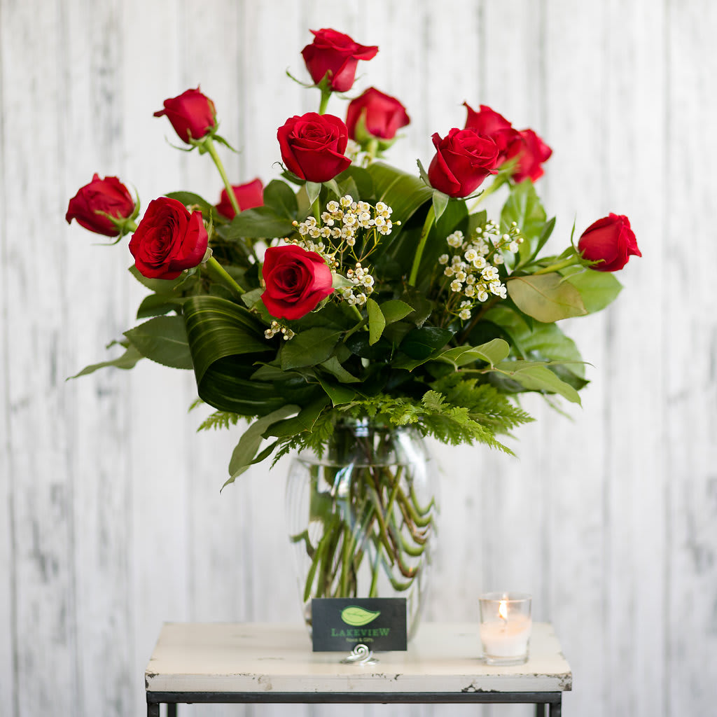 Timeless - Always a classic!  Twelve long stemmed red roses vased with textural foliage and petite filler blooms.  Approximate Dimensions: 26" H x 18" W