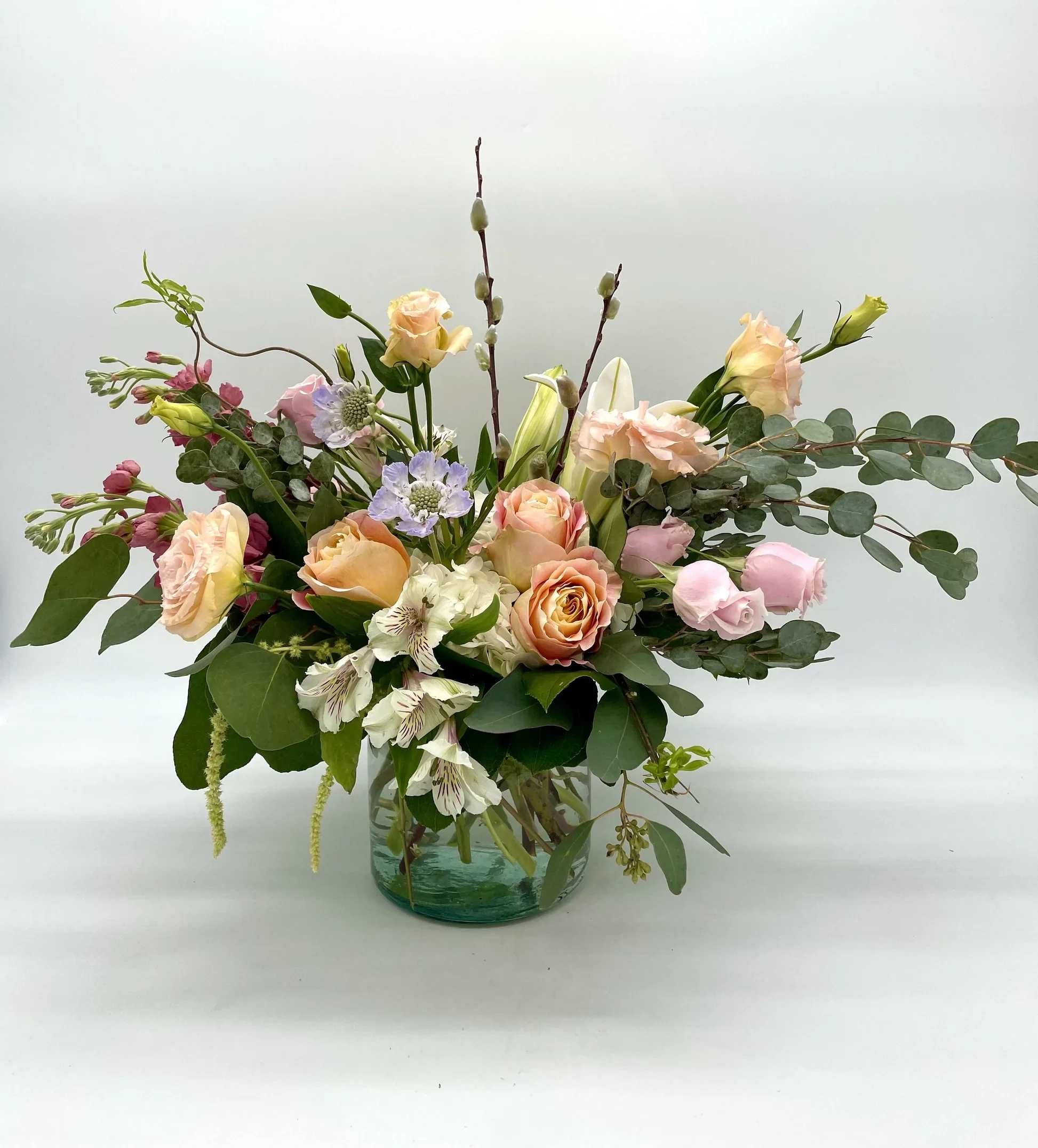 Sweet Celebration - A soft, low and lush arrangement made of whites, pinks and peaches in a 6 x 6 vase with a garden-style look. Designers may need to implement substitutions, however will follow the general arrangement style and color theme. Standard price point is pictured.