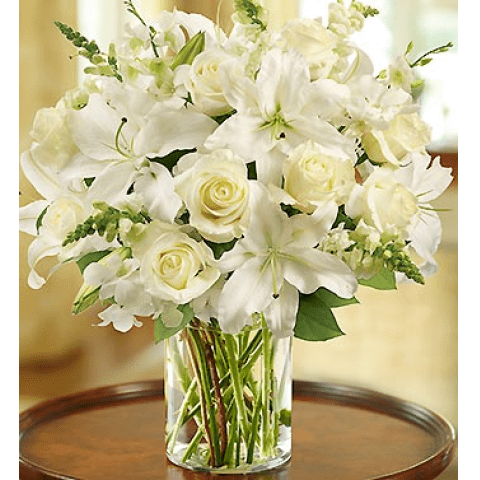  1-800-Flowers Classic All White  - Glorious roses lead the way in this luxurious white arrangement. Paired with lilies, snapdragons and salal, they're hand-gathered in a stylish cylinder vase to evoke an evening stroll.   SKU#: 90303