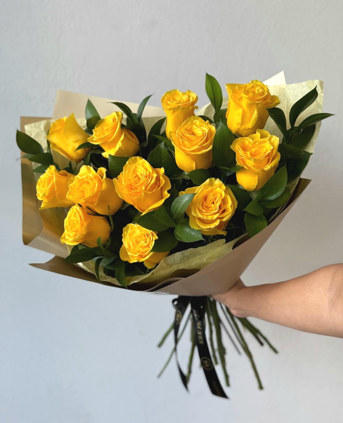 Dozen Roses "Flores Amarillas" Bouquet  - A bright and cheerful bouquet featuring vibrant of yellow roses, symbolizing joy and friendship. Wrapped elegantly for a fresh and radiant look, perfect for gifting on March 21st, Day of the Yellow Flowers.  