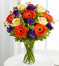  Vibrant Sunrise Bouquet - Orange Gerberas, Yellow roses, Purple lisianthis and green fillers in a vase