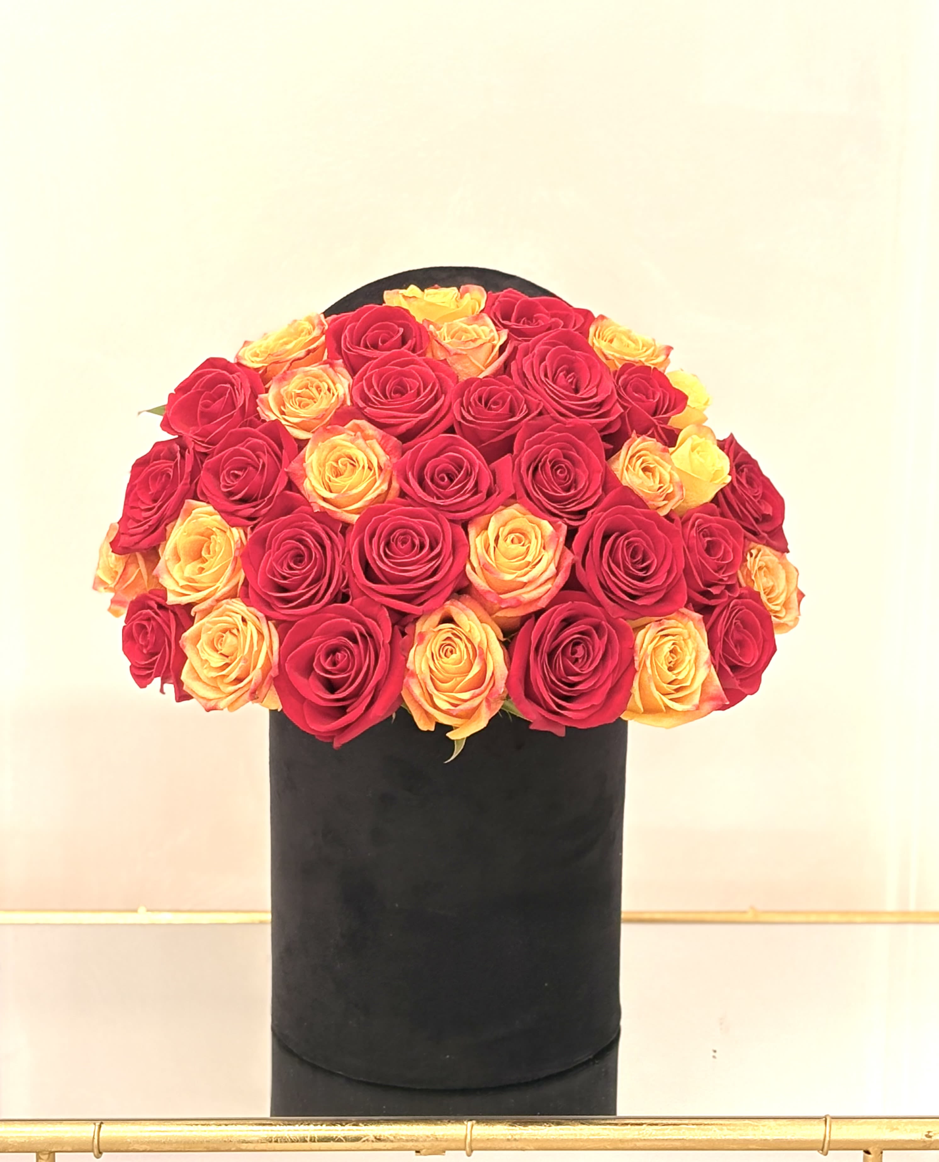  Fire &amp; Gold By VLM Flowers - Ignite the senses with this fiery mix of passionate red and radiant golden roses. “Fire &amp; Gold” symbolizes strength, love, and admiration—ideal for someone who brings light and intensity into your life. Arranged in an elegant black box for a modern, polished finish.