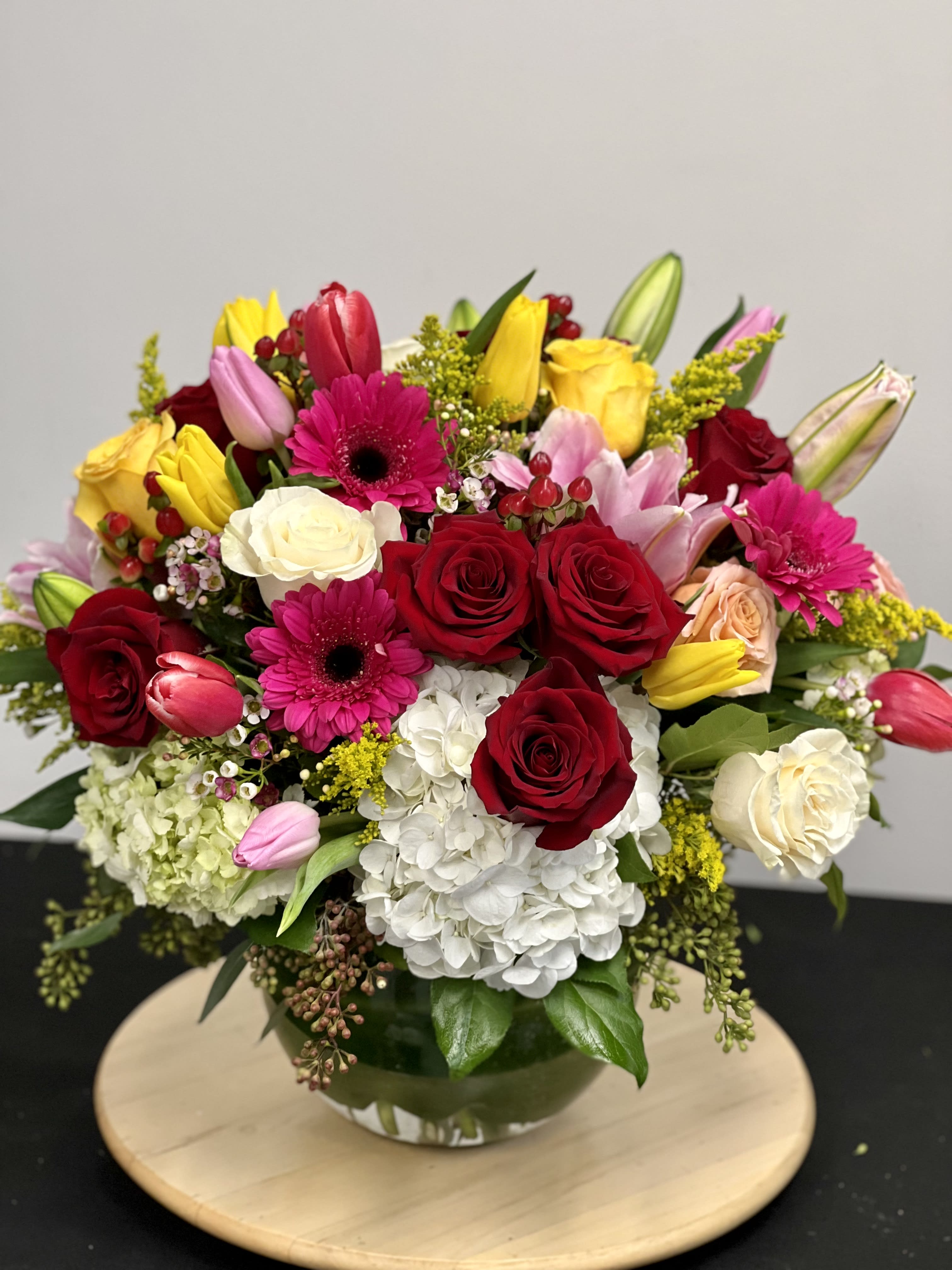 In my Garden - This garden style arrangement includes gerbera daisies, roses, tulips, lilies, and seasonal blooms. This is a great gift for all occasions.