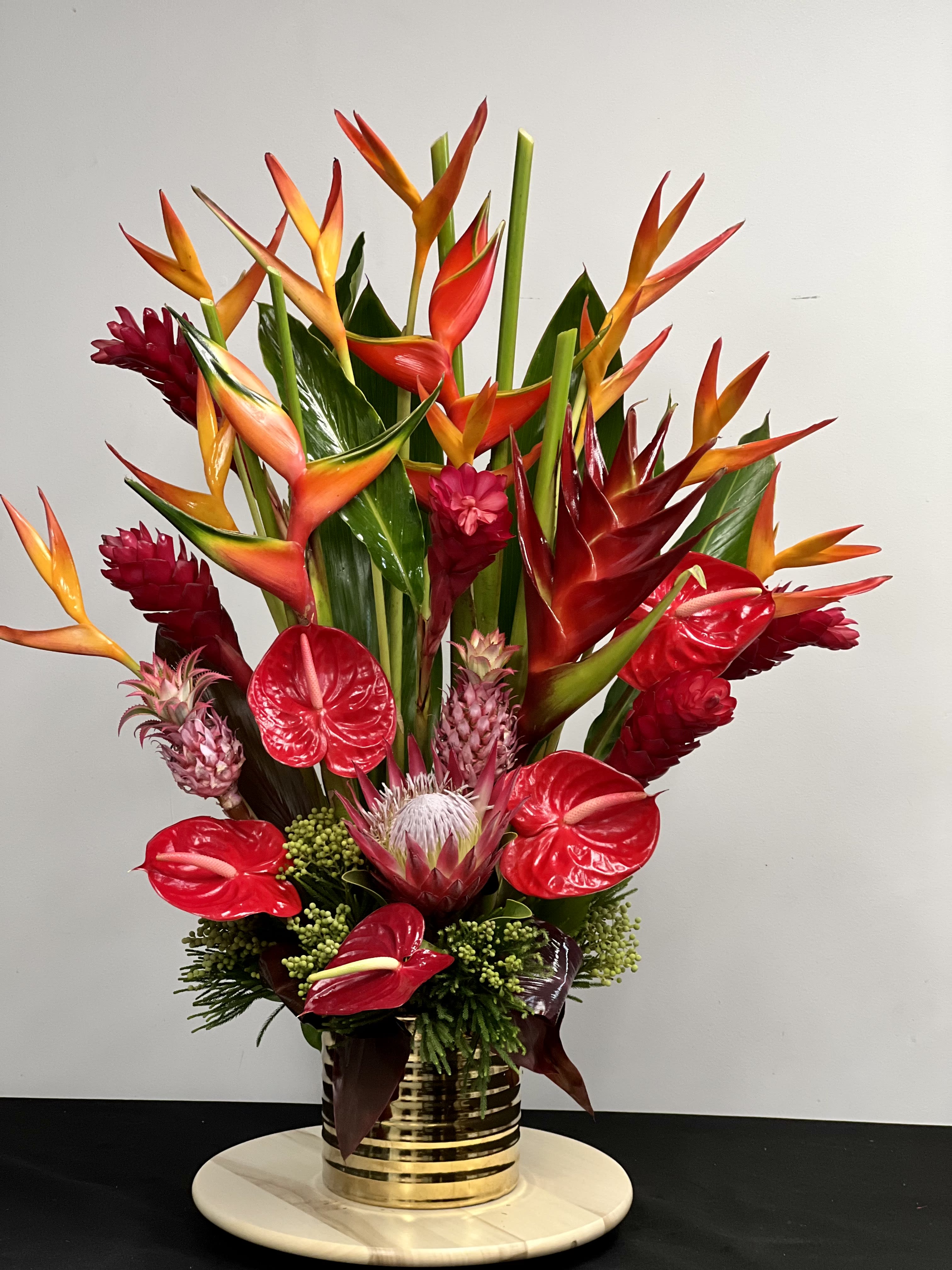 Tropical Floral Arrangement - A tropical mix of flowers. Send good feng shui someone's way with this striking arrangement.  
