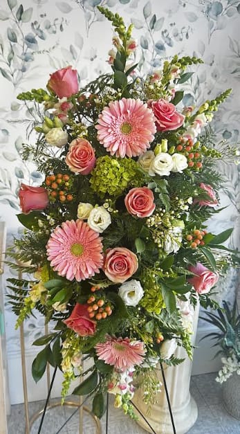Standing spray - Standing spray arranged with seasonal flowers and displayed on a standing easel. Designed to offer a beautiful and meaningful tribute for funeral and memorial services