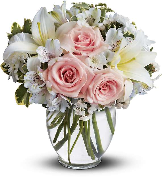 ARRIVE IN STYLE - When you want your best wishes to arrive in high style, go with this fashionable, feminine bouquet! Full and fragrant, it gathers soft pink roses with white lilies, alstroemeria and mums into a rounded ginger vase.  Light pink roses, white asiatic lilies, white alstroemeria and white cushion spray chrysanthemums are mixed with white statice and variegated pittosporum in a clear, rounded vase.