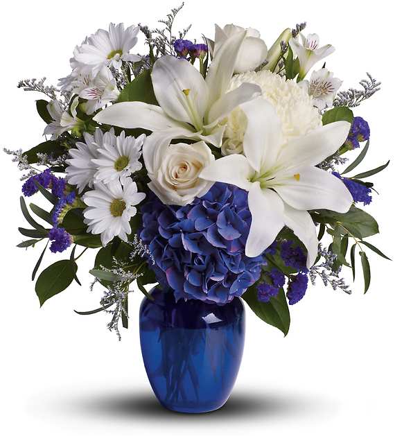 BEAUTIFUL IN BLUE - Brighten the home with the peace and beauty of a bright blue sky. This beautiful bouquet pairs pure white flowers with deep blue blooms in a gorgeous blue glass vase.  