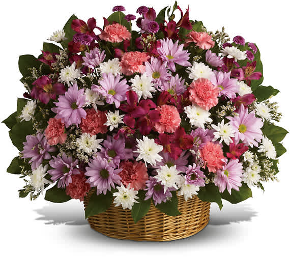 RAINBOW REFLECTIONS BASKET - Send comfort to the family with these abundant flowers beautifully contained in a wicker basket. Lavender and white chrysanthemums mix with pink alstroemeria and carnations.  Lavender daisy and button spray chrysanthemums mix with white cushion spray chrysanthemums, pink carnations and alstroemeria.