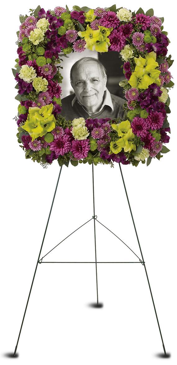 MOSAIC OF MEMORIES SQUARE EASEL WREATH - This stunning square easel wreath of purple and green flowers is a beautiful and unusual tribute to a special person whose life has brought joy to so many.  The elegant arrangement includes purple alstroemeria, green gladioli, green carnations, purple cushion spray chrysanthemums, lavender button spray chrysanthemums, green button spray chrysanthemums and purple button spray chrysanthemums, accented with assorted greenery.