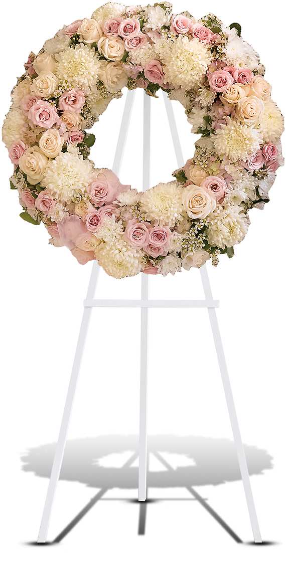 PEACE ETERNAL WREATH - A pure and delicate expression of adoration. Accented with a sheer pink organza bow, this wreath of white, crme, and pale pink petals gently embraces loving memories, and offers solace and sweet thoughts at a time of loss.  Lovely blooms such as crme and pink roses, pink hydrangea and white chrysanthemums are nestled together and accented with organza ribbon. A touching and feminine wreath, ideal for a memorial service.