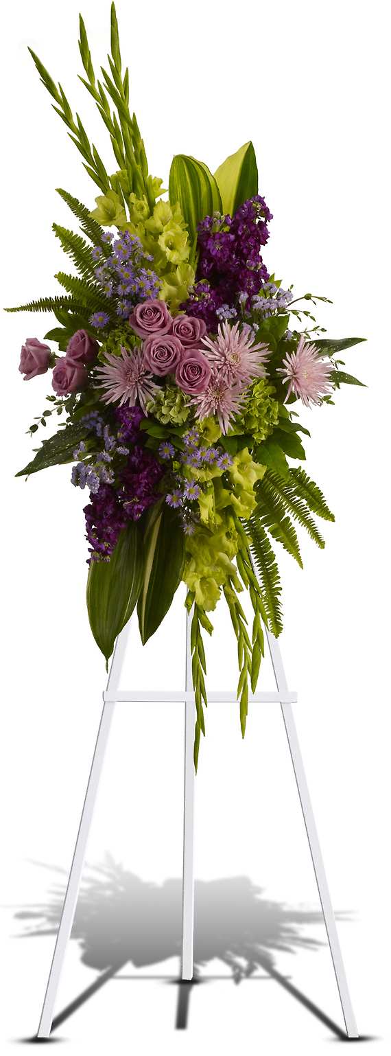 THE ENDLESS SKY SPRAY - Soft lavender flowers - roses, fuji chrysanthemums and asters - blend with rich purple stock, yellow gladioli and majestic green hydrangea in this bold floral celebration of life. This stunning standing spray incorporates lush tropical greenery.  Includes lavender larkspurs, roses, carnations and asters, plus, green cymbidium orchids and fuji chrysanthemums.