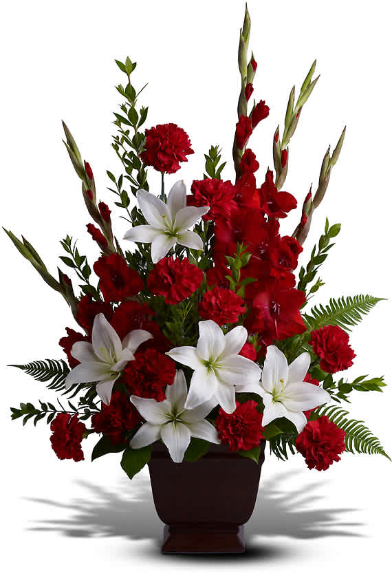 TENDER TRIBUTE - Heavenly white lilies, rich red carnations and gladioli create a touching funeral arrangement or sympathy bouquet for the service.  This red and white sympathy arrangement includes white asiatic lilies, red gladioli, red carnations, myrtle, sword fern and salal.
