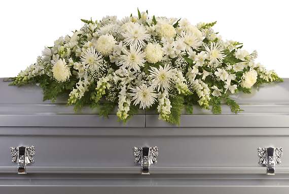 ENDURING LIGHT CASKET SPRAY - This exquisite casket spray of artistically arranged white flowers is like a blanket of love and caring. It is a very personal farewell to someone who will be deeply missed.  