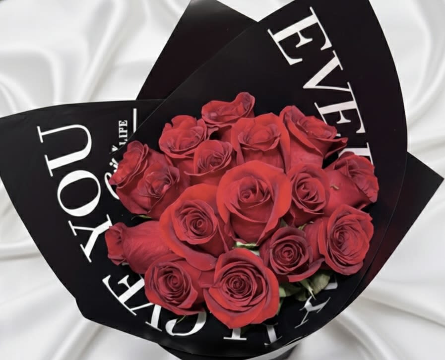 Luxury Red Rose Bouquet – Modern Black Wrap Floral Gift - Make a bold and elegant statement with our Luxury Red Rose Bouquet, a modern floral design crafted for timeless romance.  This premium arrangement features fresh red roses hand-wrapped in sleek black designer-style paper, creating a sophisticated and contemporary presentation. The striking contrast between the deep red roses and the black wrap enhances the luxury feel of this bouquet.  Available in two size options:  • 12 Red Roses – A classic and elegant romantic gesture • 20 Red Roses – A fuller, more luxurious floral expression  Perfect for anniversaries, birthdays, Valentine’s Day, romantic surprises, or any meaningful occasion.  Handcrafted by AMORE in Nashville, Tennessee. Available for local flower delivery in Nashville and surrounding areas. Same-day delivery available based on 