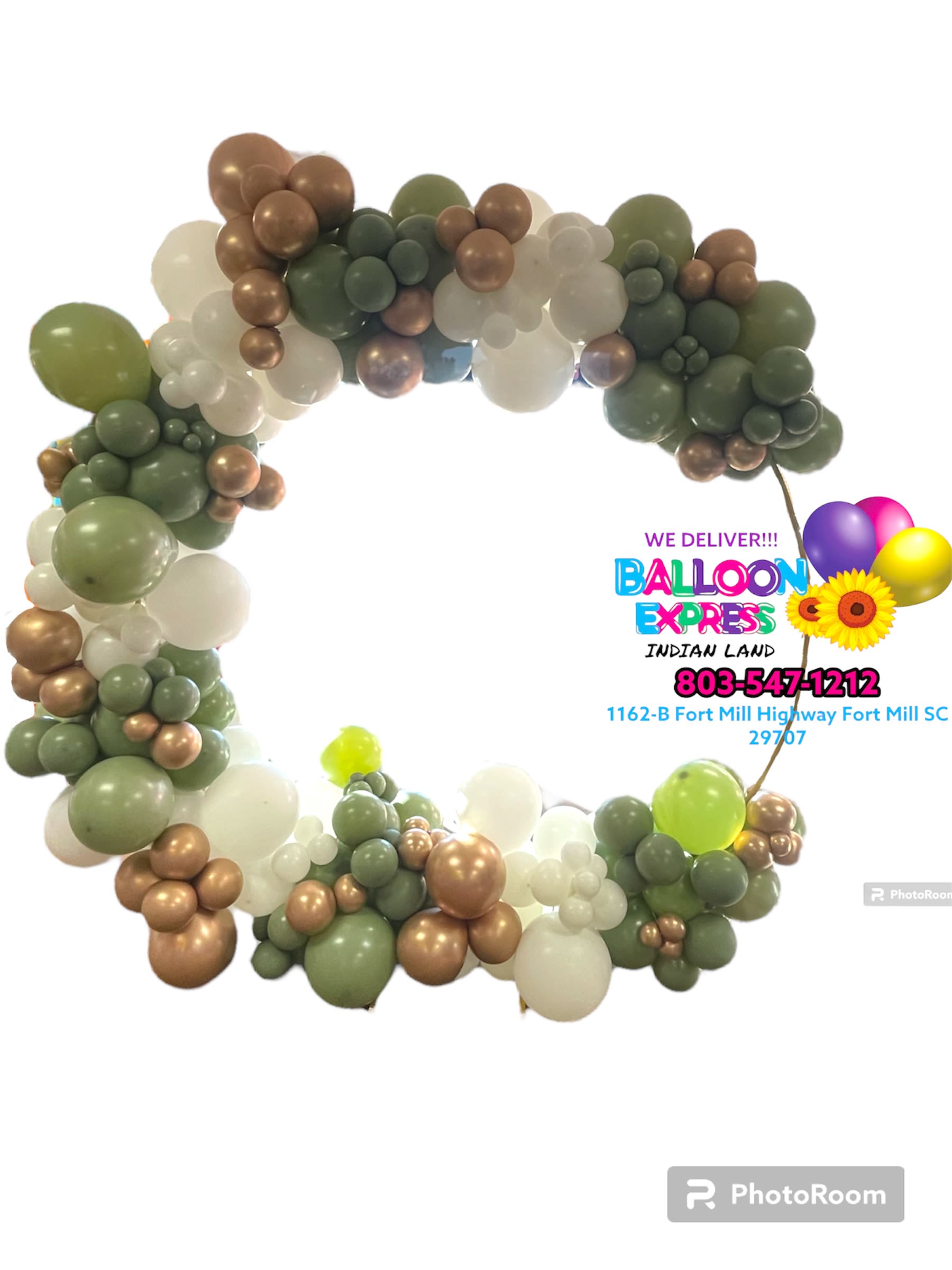 Balloon arch in green, white, and bronze tones