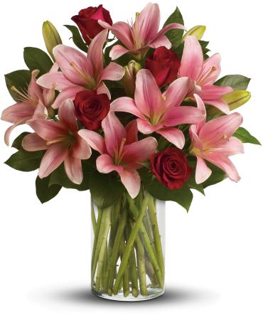 So Enchanting Bouquet -   Paint her world with enchantment! A palette of rich red roses and elegant pink lilies creates a simply stunning statement of love and devotion. It's a masterpiece she'll always remember.  Includes red roses, pink lilies and fresh lemon leaves. 