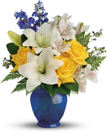 Oceanside Garden Bouquet -  Like a sunny day at the shore, this bright bouquet invigorates and inspires! Radiant yellow roses, white lilies and blue delphinium are expertly arranged in our bold blue plastic ginger jar. 