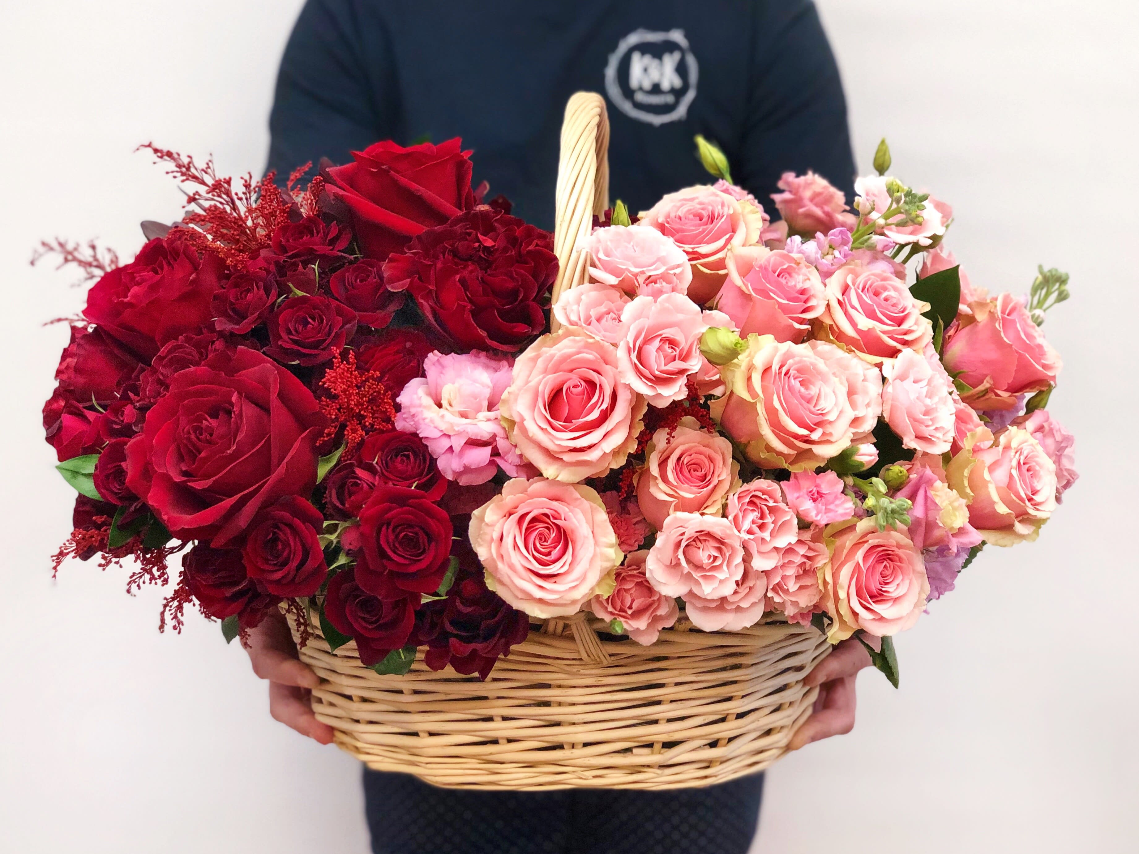 Bi-color Basket Red and Pink  - Ombre arrangement in a basket. Mix of pink and red regular roses, spray roses, lisianthus, stock etc. 