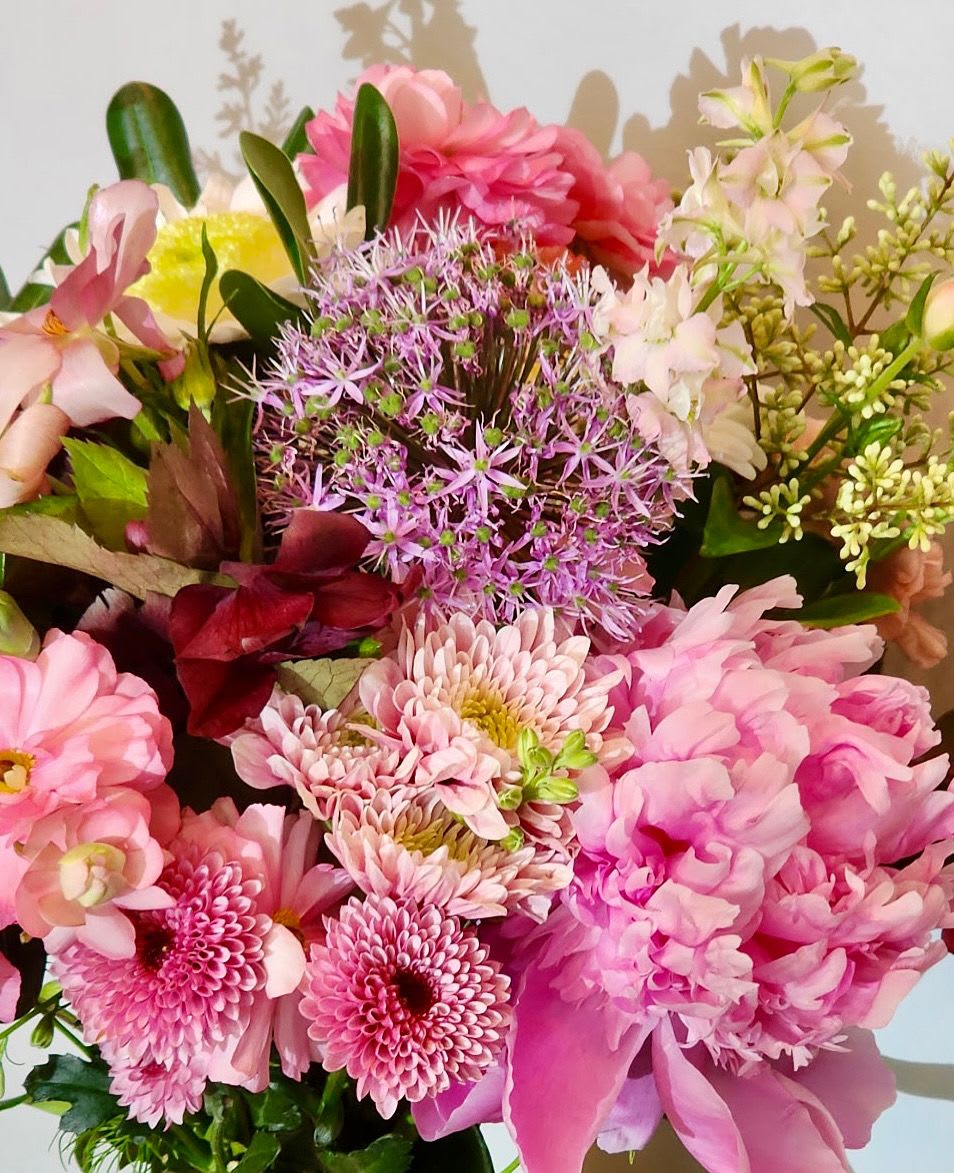 Classic Bouquet  - Our best selling bouquet. The Classic Bouquet contains a mix of seasonal flowers &amp; greenery. This bouquet would be perfect on your dining table or mantle. Can’t go wrong with a classic! The bouquet will be designers choice and hand tied in our signature wrapping.   Every effort will be made to recreate your chosen design. Please note that from time to time due to product availability and quality we may need to make substitutions. We will make sure to keep the original design in mind when making substitutions.  Please note the picture shown is an example, flowers and colors will vary