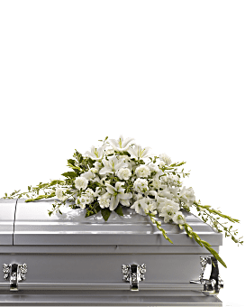White floral casket spray on a silver casket