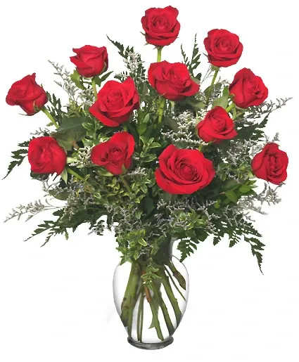 Red roses arranged in a clear glass vase