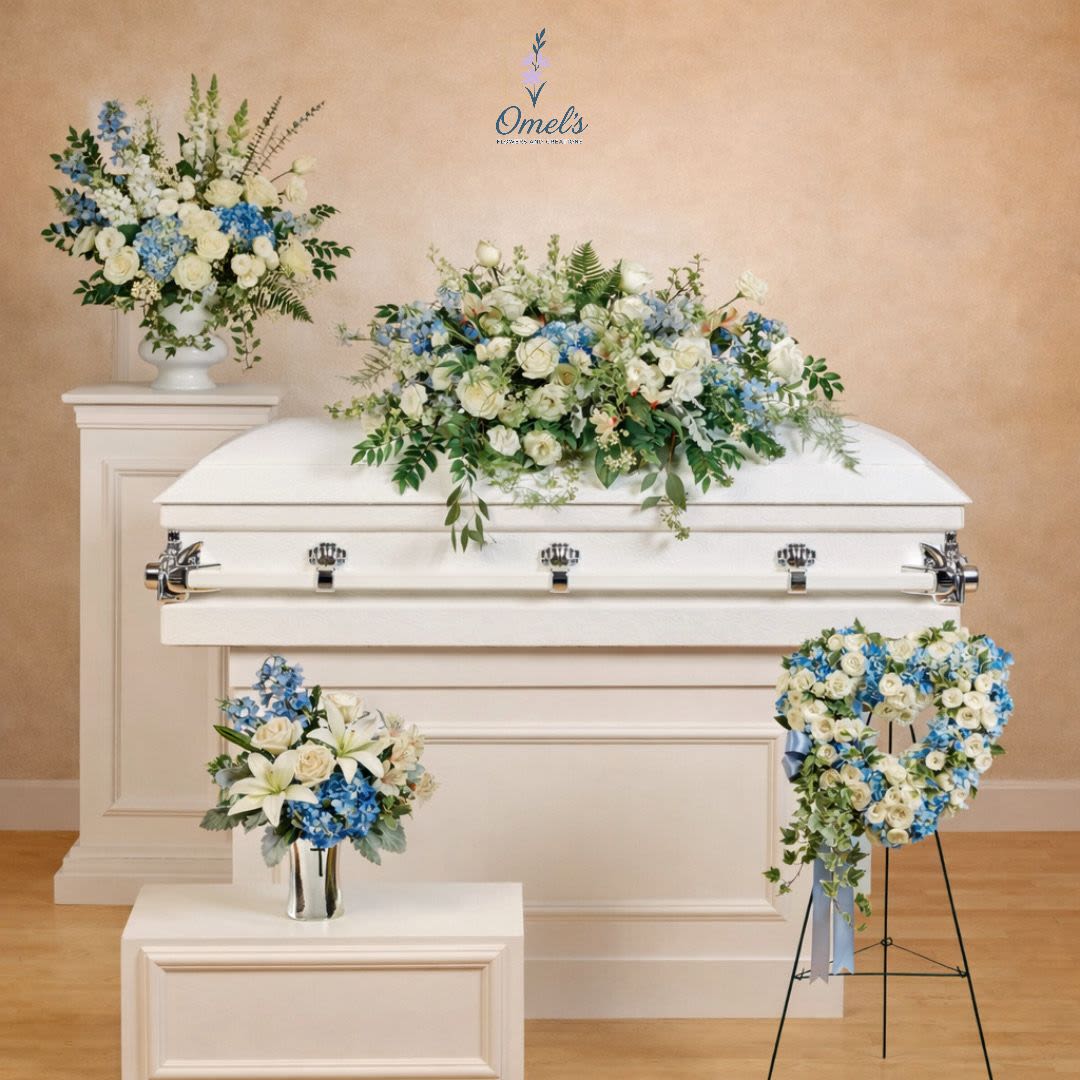 Heavenly Peace Tribute Collection - A timeless and elegant funeral floral collection designed to express peace, love, and remembrance. Featuring a coordinated casket spray, standing heart wreath, vase arrangement, and pedestal design in soft white and blue tones with roses, lilies, hydrangeas, and delicate greenery. Ideal for traditional services and families seeking a graceful and comforting tribute.