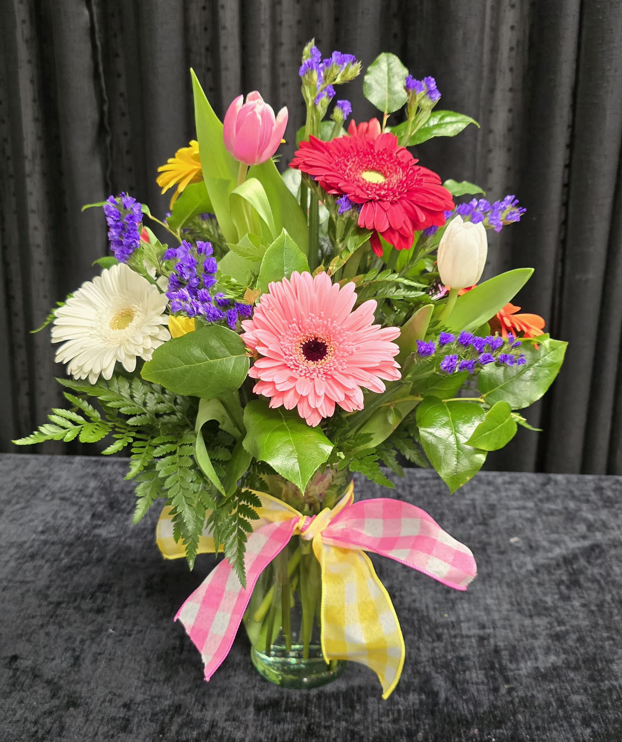 Gerbera to go go! - A bright spring arrangement with assorted gerbera daisies, tulips and filler flowers.