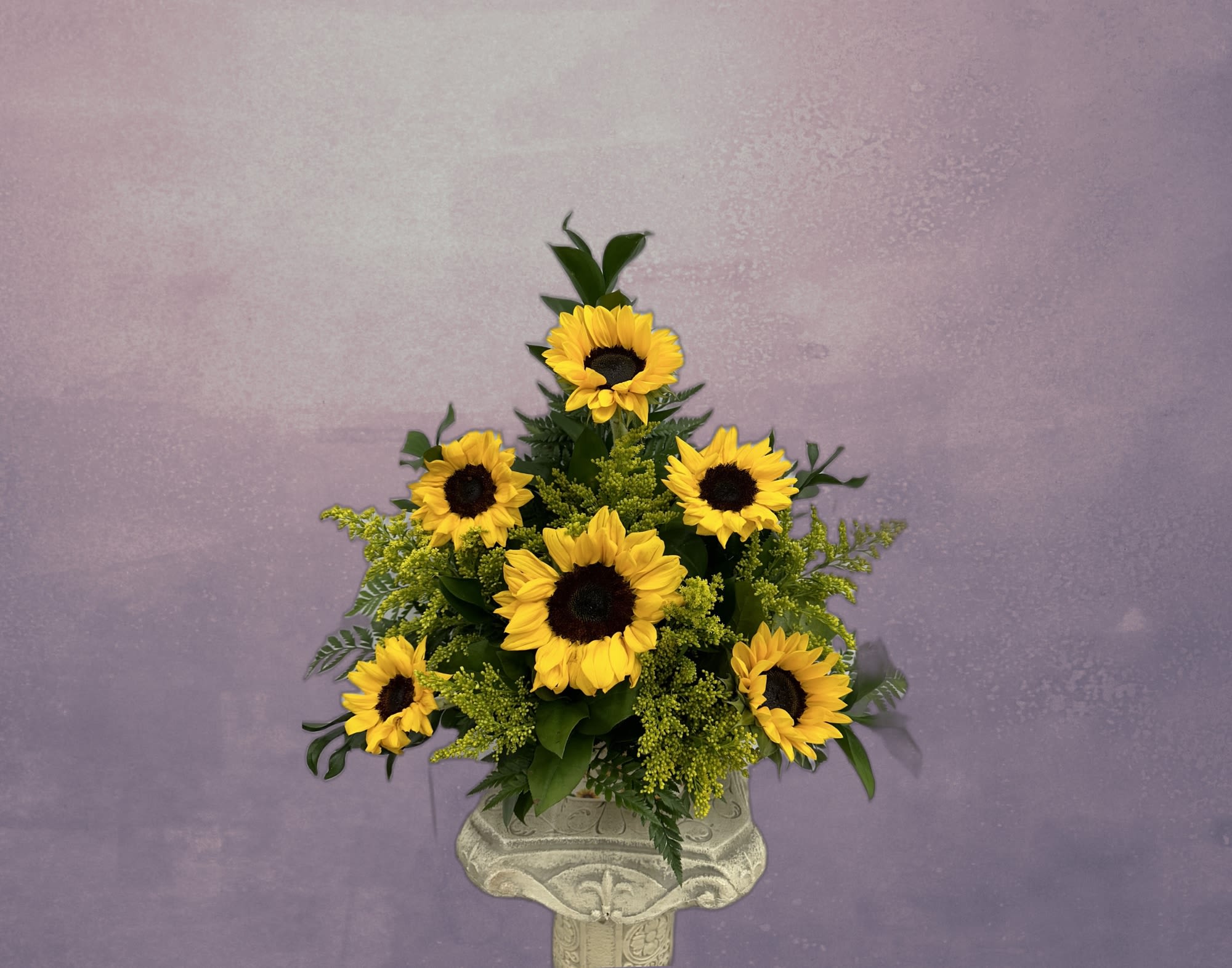 Sunflower arrangement in a decorative pedestal vase