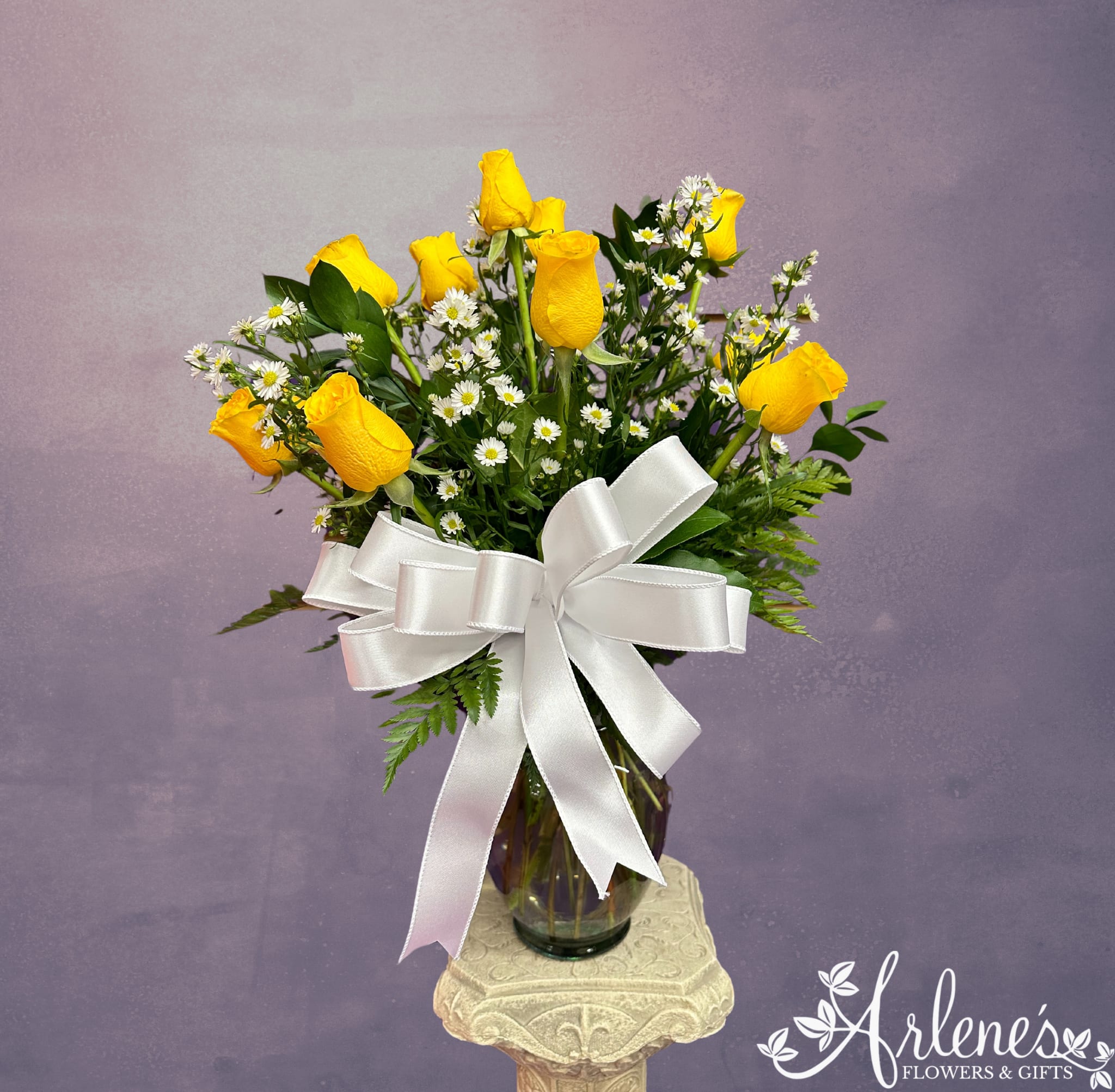 Signature Dozen Yellow Roses - A traditional dozen roses arranged with fancy greenery, filler flower and a beautiful bow.