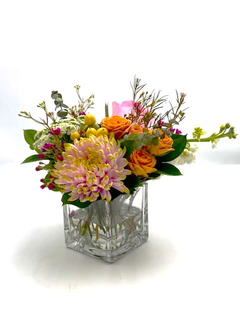 Lil Bit of Romance - Just the right size when you want to send a "lil something" to let them know how much they are loved .This thoughtful petite arrangement has roses, lace flower, spray roses, mums and eucalyptus arranged in a 4 in square vase. A scaled down arrangement with the same care and quality of our larger designs.