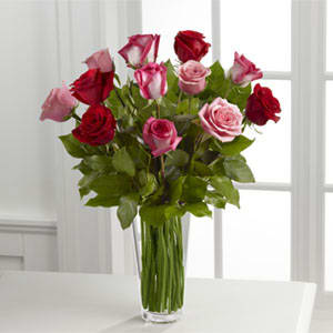  True Romance Rose Bouquet  - A bright burst of color, this bouquet combines red, pink and fuchsia roses, accented with beautiful greens and seated in a clear glass vase