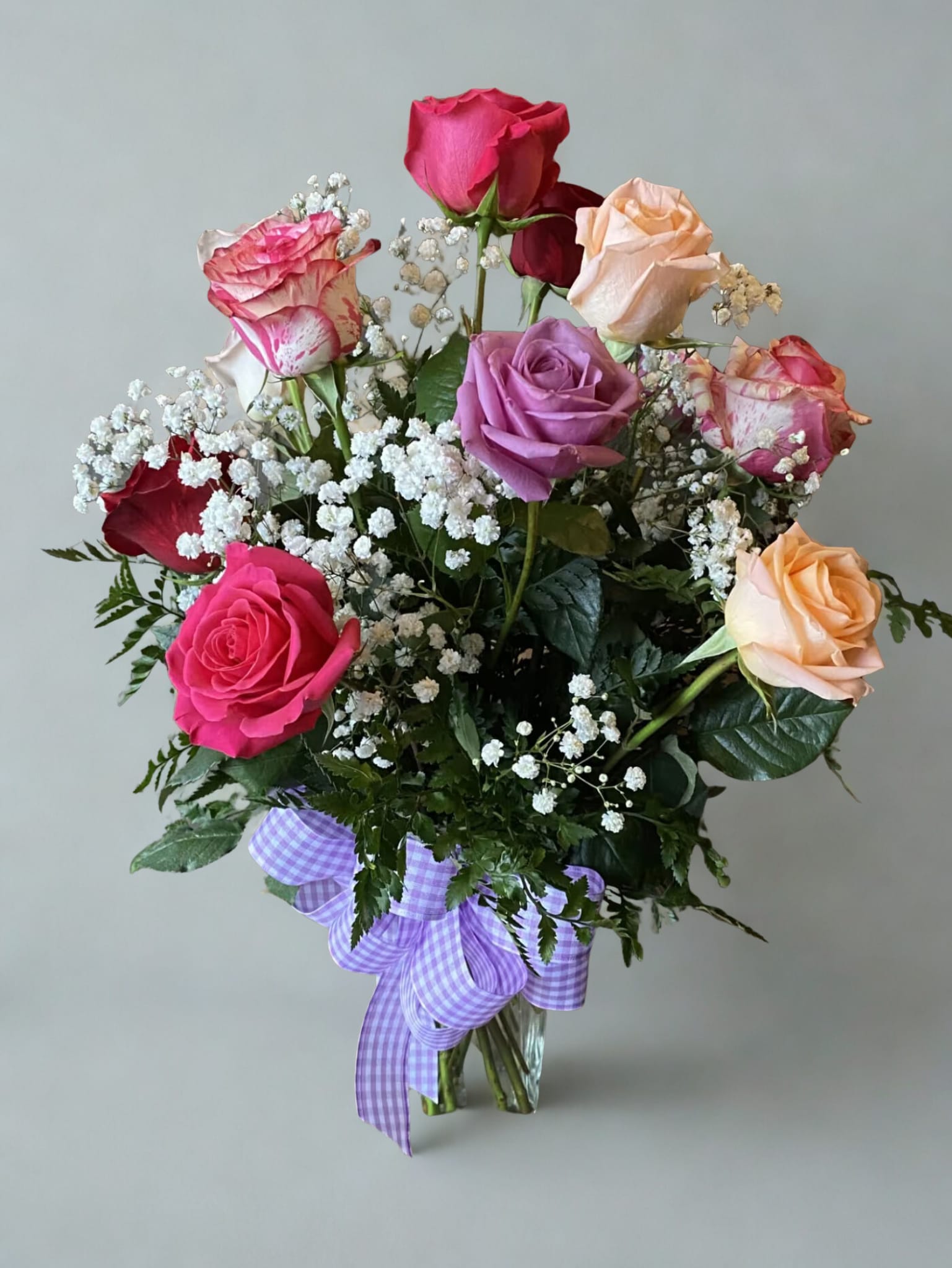 Mixed Color Dozen Roses - A beautiful assortment of mixed color roses, with greenery and babies breath and a matching bow.   All flowers, colors, vases, and ribbon may vary due to availability. 