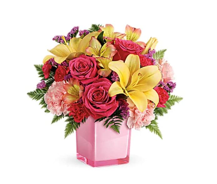 Pop Of Fun Bouquet - Turn up the fun! Make any day extra special with a surprise delivery of joyful blooms in a stylish cube vase. This bouquet of pink roses and luxurious peach lilies will make their mood soar! This fresh, fun mix of pink roses, peach asiatic lilies, peach alstroemeria, pink carnations and pink miniature carnations is accented with raspberry sinuata statice and leatherleaf fern. Delivered in a glass cube.   Orientation : One-Sided  All prices in USD ($)