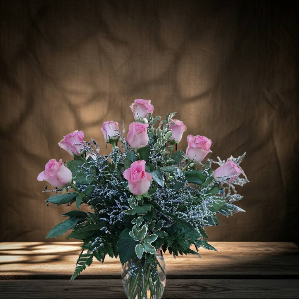 Modern Dozen Pink Roses - Dozen pink roses with caspia and greens arranged in a vase.