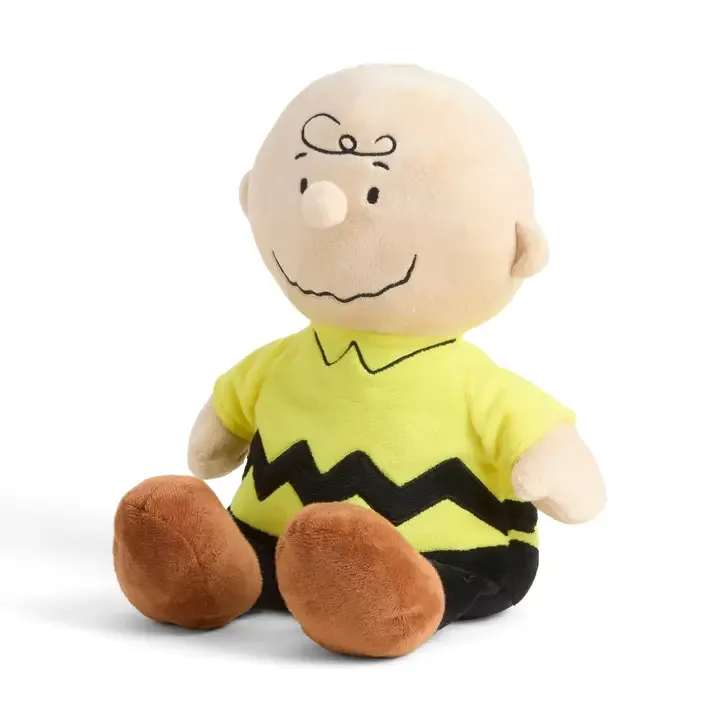 Plush Charlie Brown doll in a yellow shirt and brown shoes