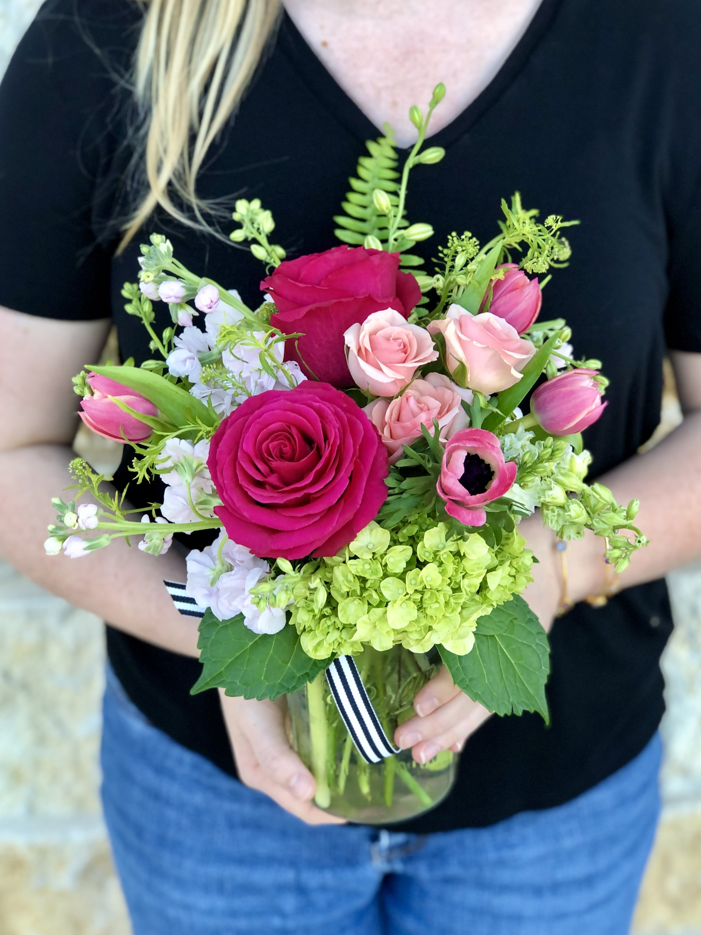 Pink Bloom Jar - A pretty seasonal garden mix in shades of soft to hot pink. Arranged in our clear glass bloom jar. Overall design is approximately 12" tall.  Floral varieties may vary but will be of similar quality and style.  