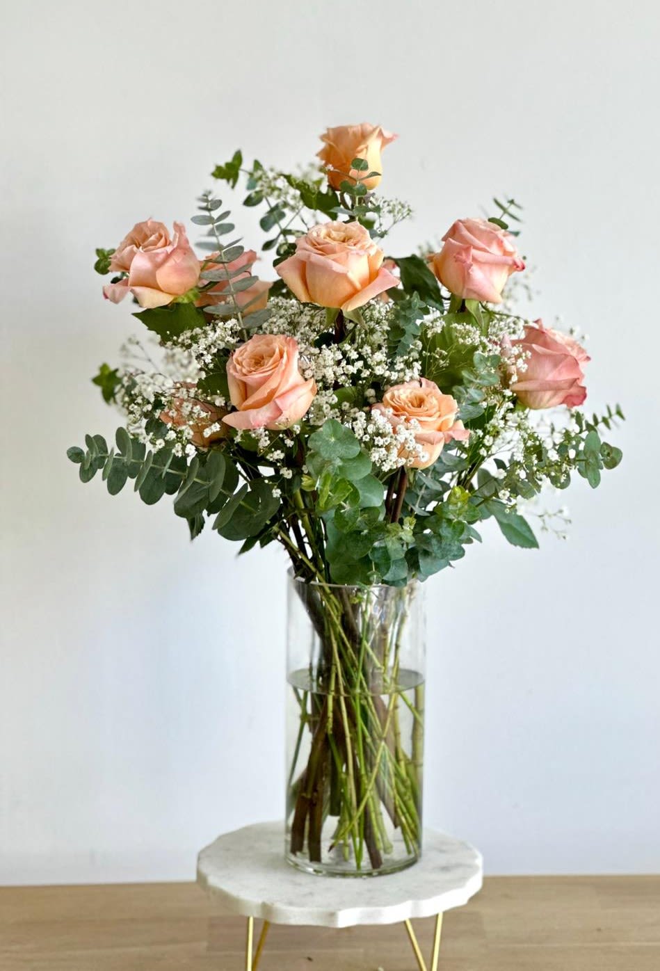 Timeless Romance in Peach  - A tall cylinder glass vase with roses, eucalyptus, and baby's breath.   Flower types may vary depending on the season.