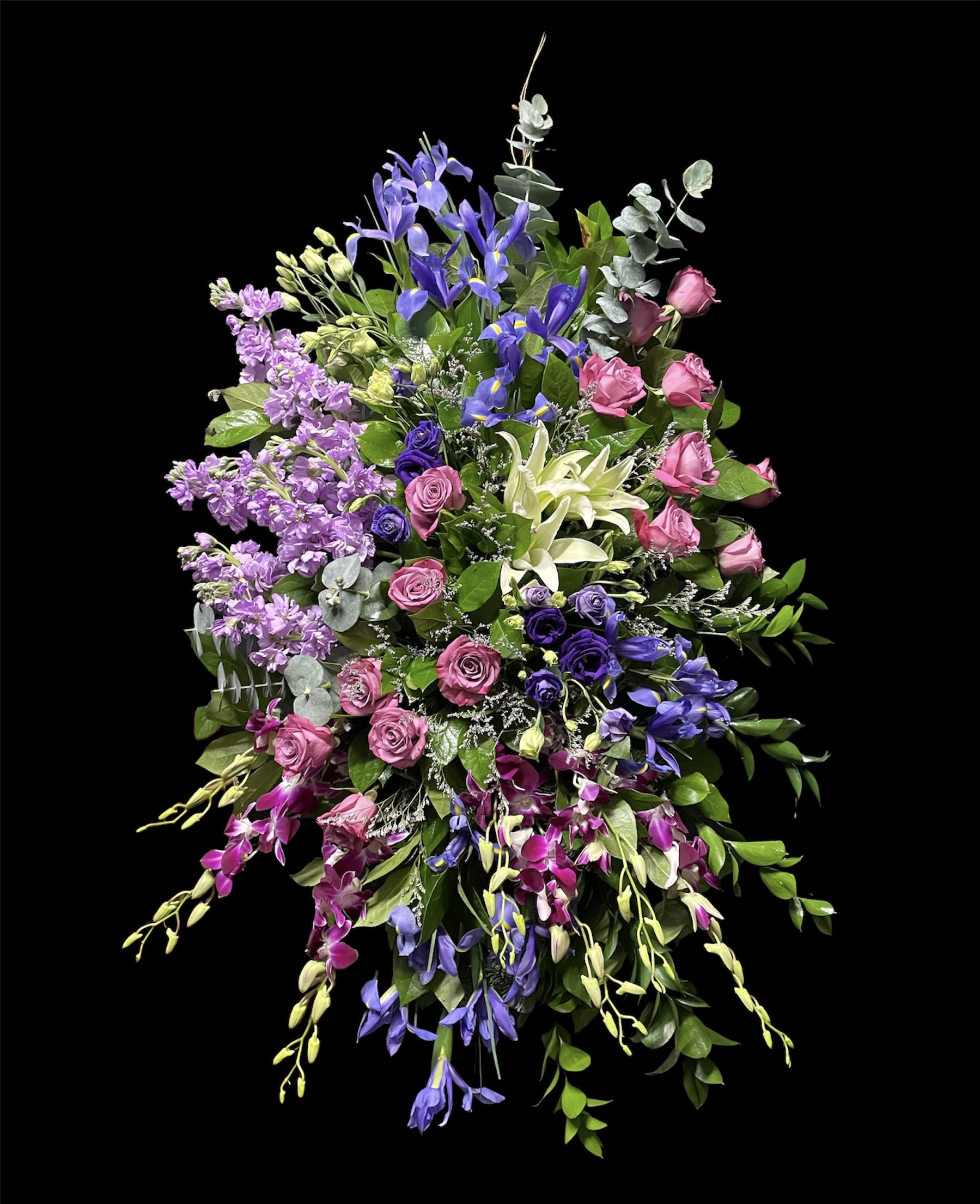 Sacred Garden Spray - A lovely lavender spray of flowers lets you share your compassion hope and beauty with all. Beautifully simple. Beautifully serene. It's the perfect way to send your sincere sympathy. Lavender purple and white flowers like hydrangea orchids roses oriental lilies and more create a beautiful spray. A wonderful tribute.Approximately 26" W x 51" H Orientation: One-Sided As Shown : T249-4A