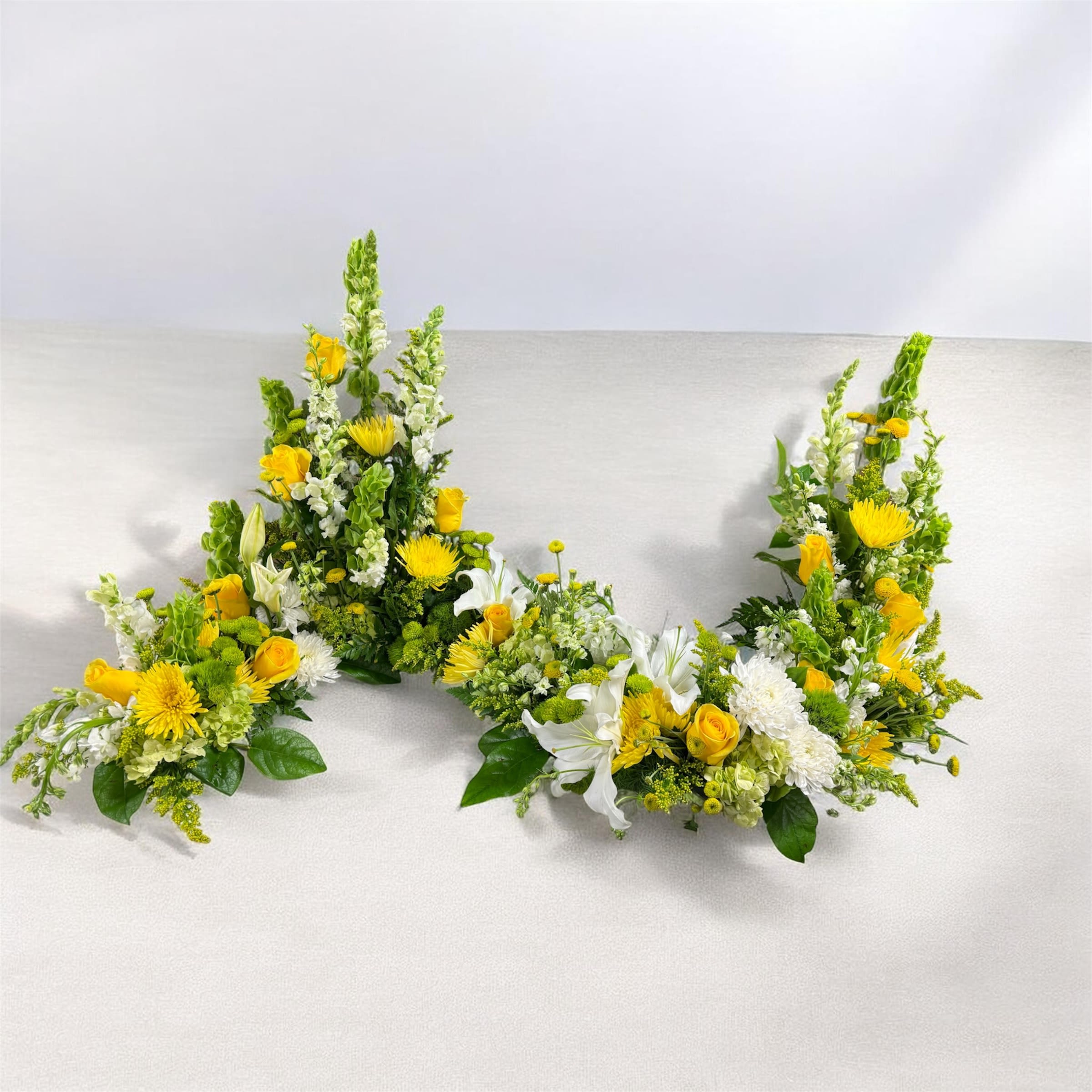 Cremation “S” curved arrangement - In the shape of an “S” allowing for an urn to be displayed on one side and a picture on the other.