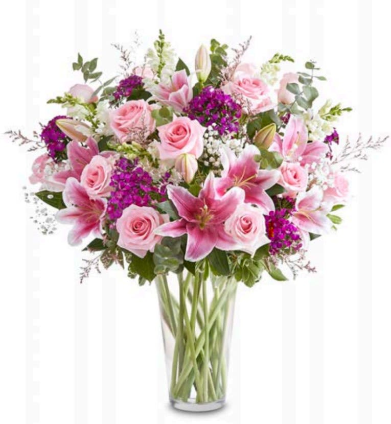 Mom's Garden Delight - This stunning arrangement features a variety of brightly colored flowers displayed in a vase.