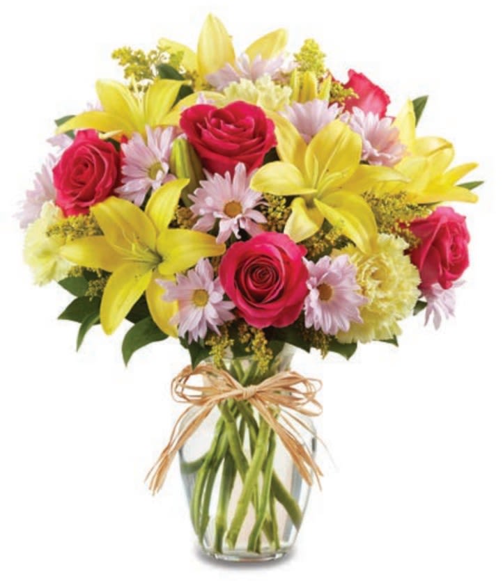 Mom's Countryside Bouquet - Bring the beauty of a sun-drenched meadow indoors with Mom’s Countryside Bouquet. This charming arrangement features a cheerful mix of bright yellow daisies, hot pink carnations, and deep purple accent flowers, all nestled in a classic glass vase. It’s a rustic, "just-picked" look that’s perfect for showing Mom exactly how much she’s loved.