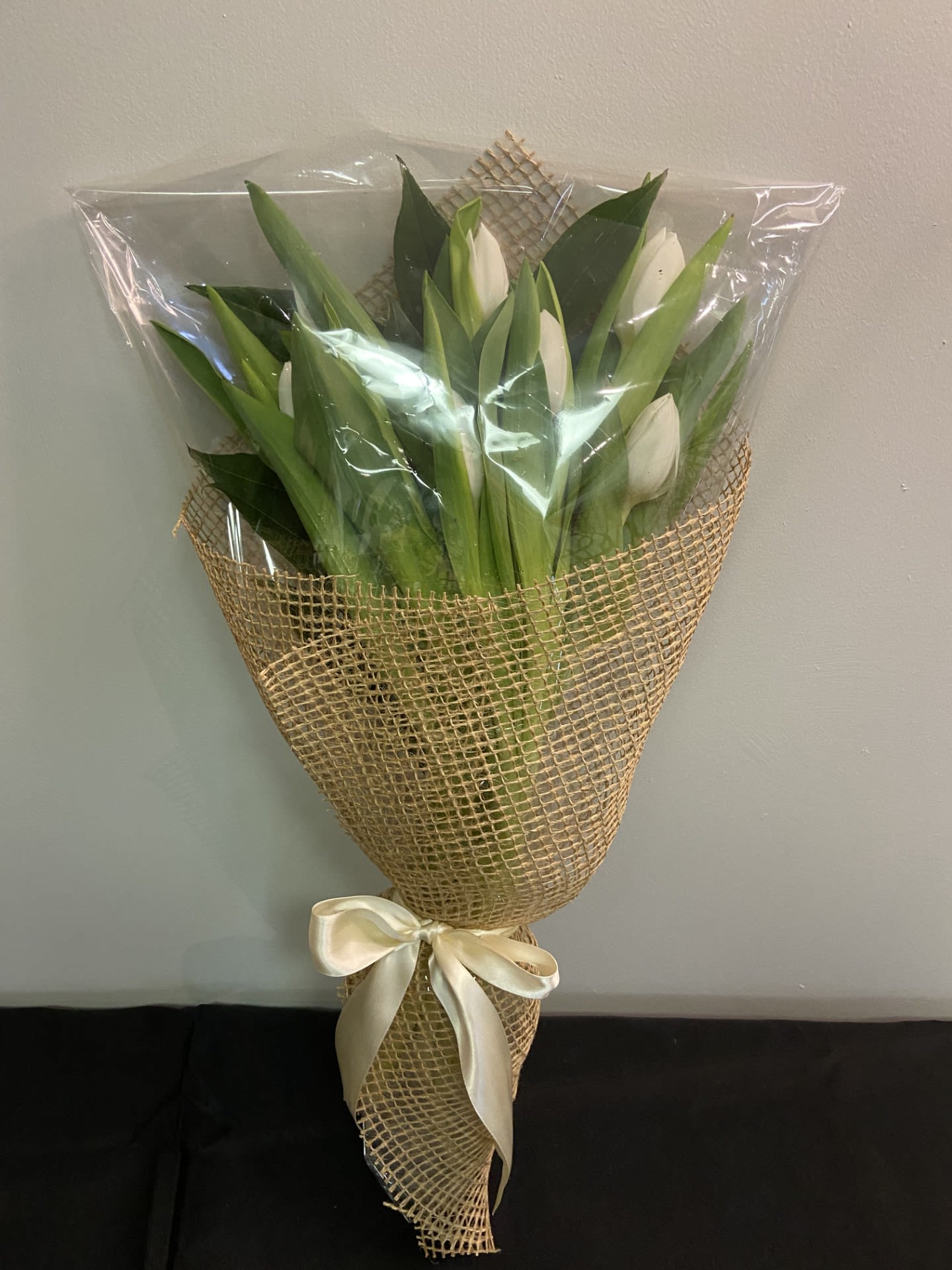 Tulip Treasure Bouquet by Chasing Petals - A bouquet of tulips wrapped in elegant burlap.   Available in a variety of colours, please call to inquire about alternative colours.