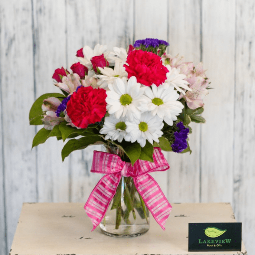 Delight - Simple and sweet, this mix of long lasting daisies, alstroemeria, carnations &amp; spray roses is sure to brighten anyone's day!  Approximate Dimensions: 14" H x 10" W