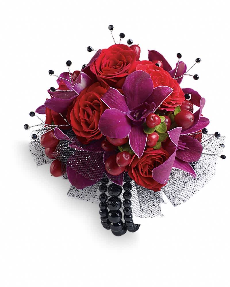 Celebrity Style Corsage - Flirt with fame in this feminine arrangement of exotic orchids, roses and hypericum. Purple dendrobium orchids, red spray roses and red hypericum with black rhinestone accents.